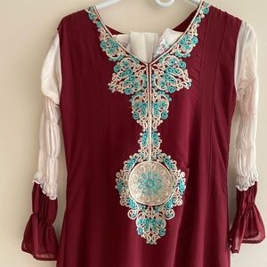 Maroon dress with light blue and white embroidery